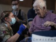 Veterans receive vaccines from troops