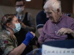 Veterans receive vaccines from troops