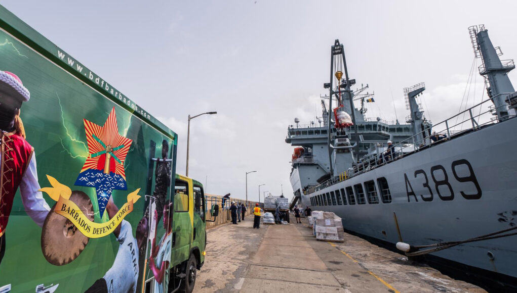 The Barbados Defence Force delivers aid to the jetty for loading on to RFA Wave Knight