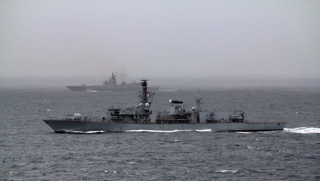 HMS Portland in the foreground and the Russian frigate in the background