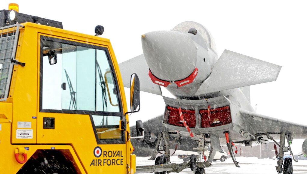 RAF_Typhoon_Jet_is_Towed_from_its_Hangar_at_RAF_Coningsby_in_the_Snow_MOD_45152131