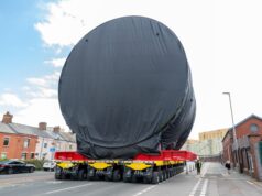 Massive submarine section makes way through town