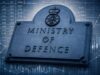 PAC warns MoD fraud risk is vast as recoveries fall short Stone plaque reading MINISTRY OF DEFENCE with a crown crest, set against blue-toned financial charts and graphs in the background by overlay.