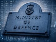 PAC warns MoD fraud risk is vast as recoveries fall short Stone plaque reading MINISTRY OF DEFENCE with a crown crest, set against blue-toned financial charts and graphs in the background by overlay.