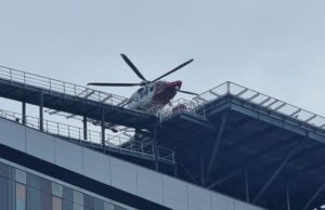 Glasgow hospital helipad passes 3,000 landings since 2015 Emergency helicopter parked on a rooftop helipad above a modern glass office building