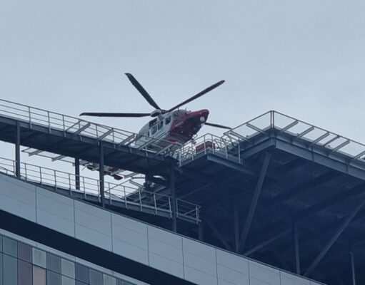 Glasgow hospital helipad passes 3,000 landings since 2015 Emergency helicopter parked on a rooftop helipad above a modern glass office building