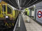 British Army runs NATO corps HQ in London Tube station Yellow maintenance locomotive on a London Underground platform at Charing Cross, with green wall tiles and passengers in the background.