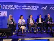 Primes say supply chain must change at DPRTE Scotland Five panelists seated on stage at the Scottish Defence Procurement & Supply Chain Summit 2026, with a blue-lit backdrop and sponsor logos.