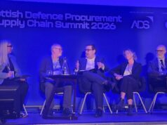 Five panelists seated on stage during the Scottish Defence Procurement & Supply Chain Summit 2026, blue-lit backdrop with sponsor logos.