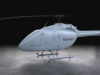 Light gray Marine helicopter with 'MARINES' on the side, parked on a concrete floor in a dark studio.