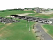 3D aerial view of a solar farm with rows of panels and a wind turbine beside a runway-like airstrip on green fields.