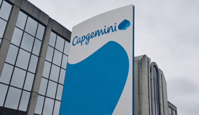 Capgemini signs multi-year tech deal with BAE Systems Capgemini corporate sign with blue curved graphic on a tall white panel beside a glass-front building exterior