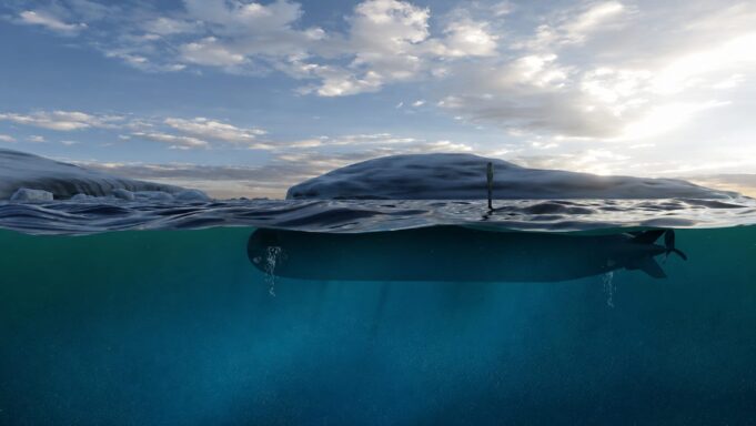 Submarine partially submerged with the hull just below the surface and a periscope rising above the water under a cloudy sky.