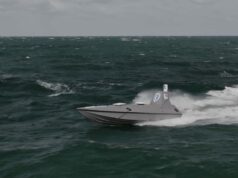 Beehive may be another Dreadnought moment Gray speedboat racing across choppy dark green ocean with white spray at the stern, under a cloudy sky.