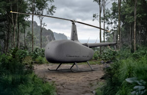 Grey autonomous helicopter drone with a two-bladed rotor on a forest path, rugged landing skids, surrounded by dense jungle.