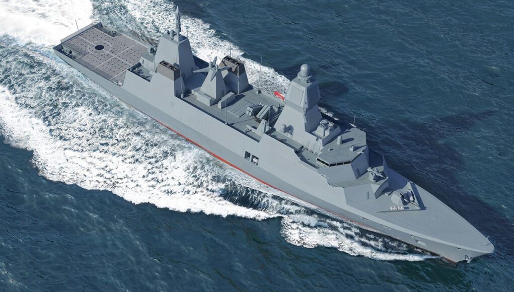 Modern gray destroyer cruising through open sea, bow to the right, leaving a frothy wake behind.