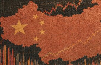 Cracked red silhouette of China with yellow stars over a rising stock chart background.