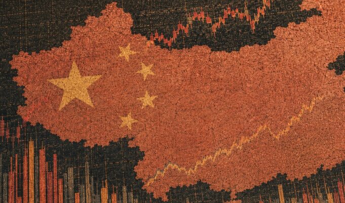 Cracked red silhouette of China with yellow stars over a rising stock chart background.