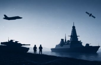 Silhouetted military scene with a tank on shore, two soldiers, a battleship, a jet overhead, and a satellite in a blue sky.