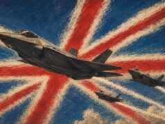 Three fighter jets soar over a distressed Union Jack background, leaving white smoke trails in red and blue.