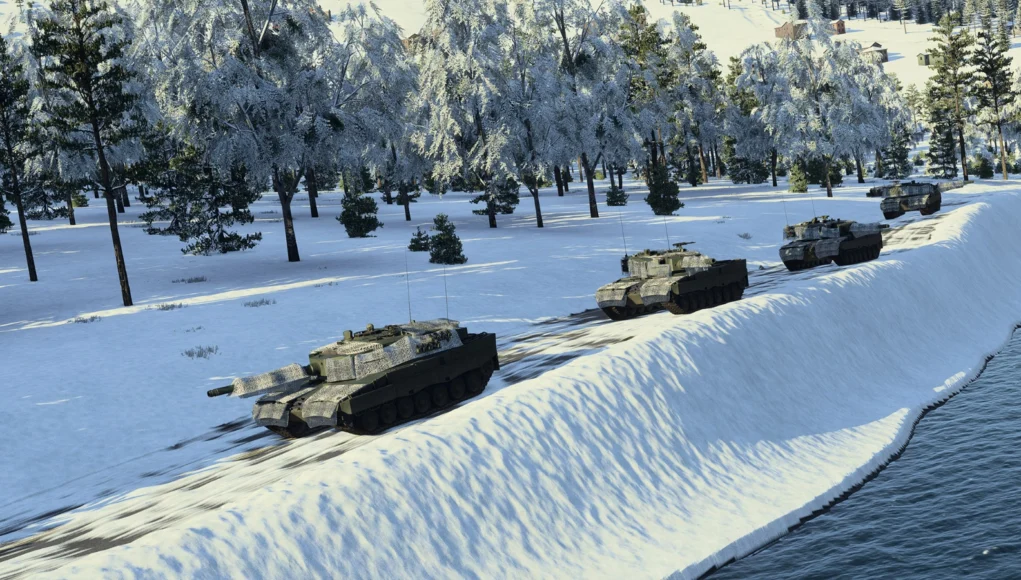 Line of armored tanks driving along a snow-covered riverbank with a forest of frosted trees in the background