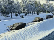 Line of armored tanks driving along a snow-covered riverbank with a forest of frosted trees in the background