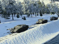 Line of armored tanks driving along a snow-covered riverbank with a forest of frosted trees in the background
