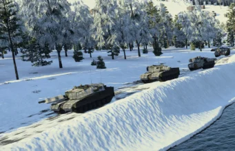 Line of armored tanks driving along a snow-covered riverbank with a forest of frosted trees in the background
