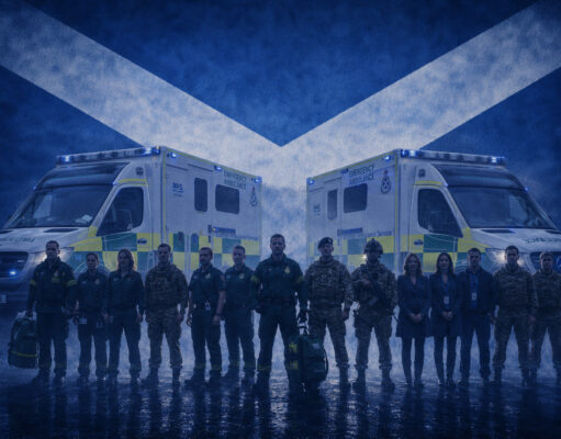 Scottish Ambulance Service backs reservists Emergency responders in uniform stand in front of two NHS emergency ambulances with a Scottish flag backdrop behind them.