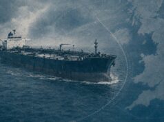 Large oil tanker sailing on choppy blue ocean with a map-like blue overlay in the background, conveying global shipping routes