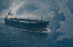 Large oil tanker sailing on choppy blue ocean with a map-like blue overlay in the background, conveying global shipping routes