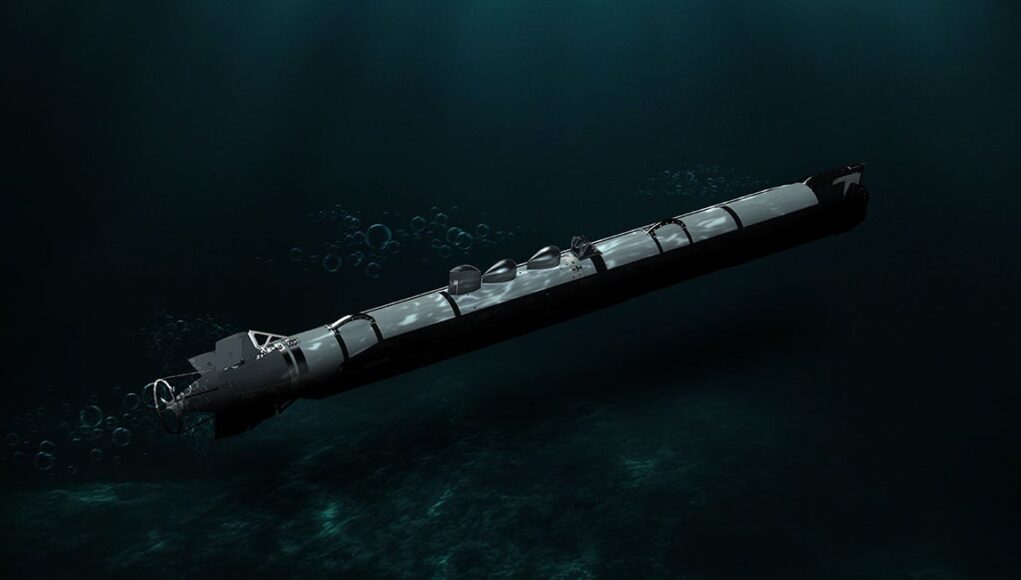 Torpedo submerged in dark ocean water, trailing bubbles as it drifts forward.
