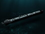 Torpedo submerged in dark ocean water, trailing bubbles as it drifts forward.