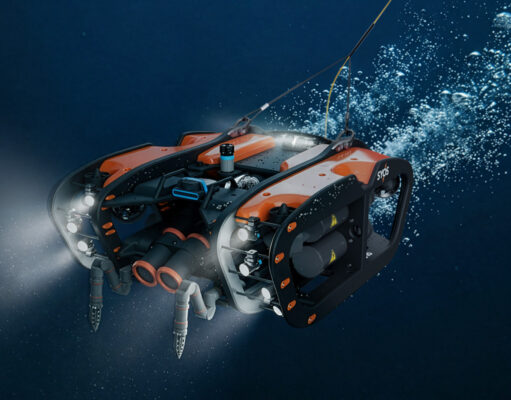 SYOS unveils underwater drone to complete multi-domain portfolio Underwater orange-and-black submersible drone with lights cruising through deep blue water.