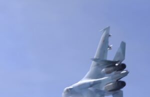 Russian jet dangerously close to British military aircraft Blurred fighter jet ascending into a clear blue sky, twin vertical tails visible at the rear.