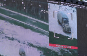 NATO has a counter-drone problem – inside the race to fix it Surveillance display highlighting a truck on a road, with a crosshair overlay and a red 'Tracking ATTACK' label below the image.