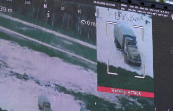 NATO has a counter-drone problem – inside the race to fix it Surveillance display highlighting a truck on a road, with a crosshair overlay and a red 'Tracking ATTACK' label below the image.