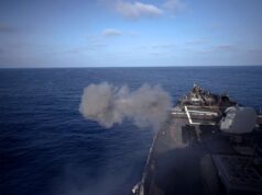 American destroyer opens fire in the Mediterranean Military ship’s flight/deck at sea with a smoke plume near the bow and open ocean ahead.