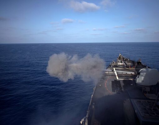 American destroyer opens fire in the Mediterranean Military ship’s flight/deck at sea with a smoke plume near the bow and open ocean ahead.
