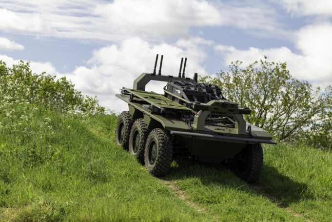 Leonardo deal lets IDV build the Viking UGV at scale Eight-wheeled armored military vehicle on a grassy slope under a cloudy sky, with equipment racks and antennas mounted on top.