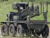 British-built brain lets UGVs navigate when GPS goes down Eight-wheeled armored unmanned ground vehicle with a mounted sensor turret on a grassy field.