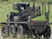 British-built brain lets UGVs navigate when GPS goes down Eight-wheeled armored unmanned ground vehicle with a mounted sensor turret on a grassy field.