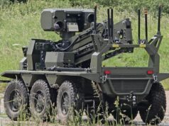 British-built brain lets UGVs navigate when GPS goes down Eight-wheeled armored unmanned ground vehicle with a mounted sensor turret on a grassy field.