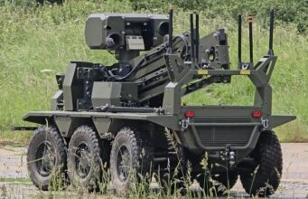 British-built brain lets UGVs navigate when GPS goes down Eight-wheeled armored unmanned ground vehicle with a mounted sensor turret on a grassy field.