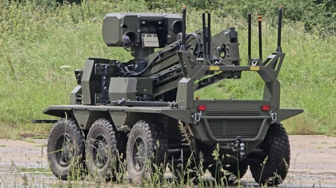British-built brain lets UGVs navigate when GPS goes down Eight-wheeled armored unmanned ground vehicle with a mounted sensor turret on a grassy field.