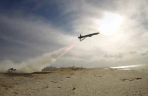 British long range deep-strike weapon passes key trial Air tanker plane releasing red retardant over a sandy beach as smoke rises from a ground fire nearby