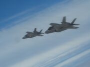NATO issues first nuclear statement in message to Moscow Two gray fighter jets flying in formation across a blue sky.