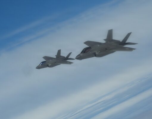 NATO issues first nuclear statement in message to Moscow Two gray fighter jets flying in formation across a blue sky.