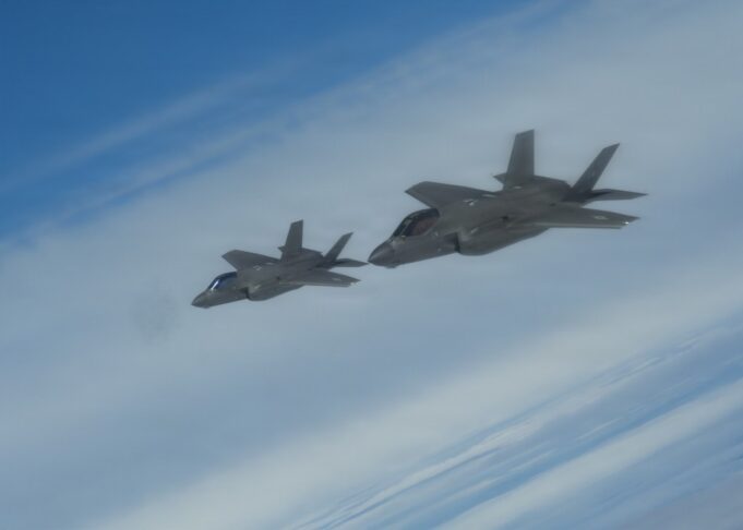 NATO issues first nuclear statement in message to Moscow Two gray fighter jets flying in formation across a blue sky.