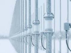 Australia exports over-the-horizon radar to Canada Row of snow-dusted streetlight posts along a railing in a snowy landscape, receding into the distance.